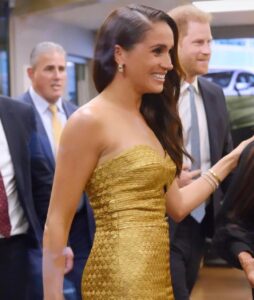 Meghan Markle in gold gown with Surprise Guests Prince Harry for post-coronation award