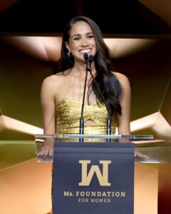 Meghan Markle in gold gown with Surprise Guests Prince Harry for post-coronation award